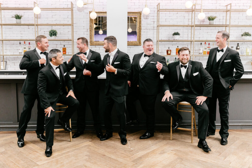 groom laughing with his groomsmen before Cescaphe wedding reception