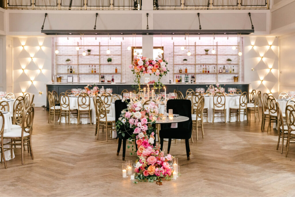 vibrant pink floral sweetheart table at Cescaphe wedding reception by Emily Wren Photography