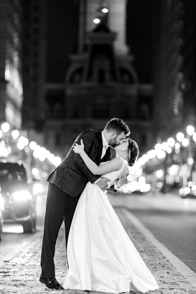 bride & groom night portrait on Broad Street in Philadelphia in front of city hall by luxurious wedding photographer Emily Wren Photography