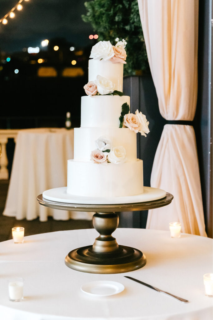 four tier wedding cake with pink and white flowers