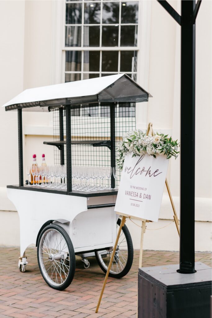 Welcome sign and champagne cart at Cescaphe wedding ceremony