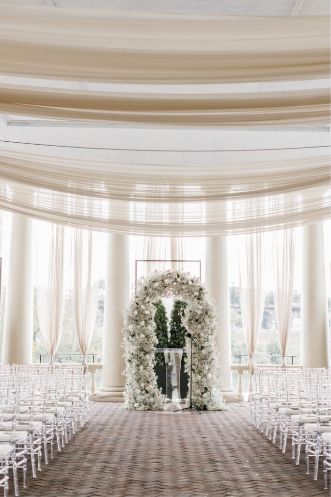 Cescaphe's Grand Pavillion at Waterworks wedding ceremony with white floral arch with greenery