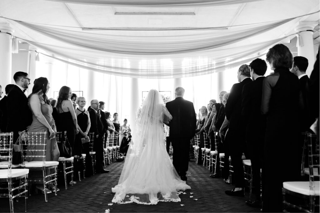 bride walking down the aisle under sheer white tent at Philadelphia Water Works