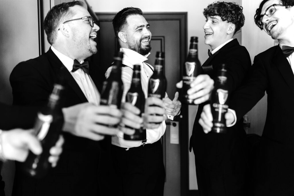 groom drinking with his groomsmen before his luxury Cescaphe wedding