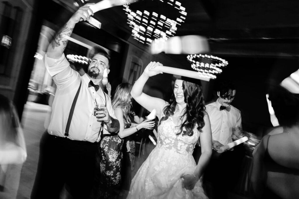 bride & groom having fun at their Spring Cescaphe wedding reception by Emily Wren Photography