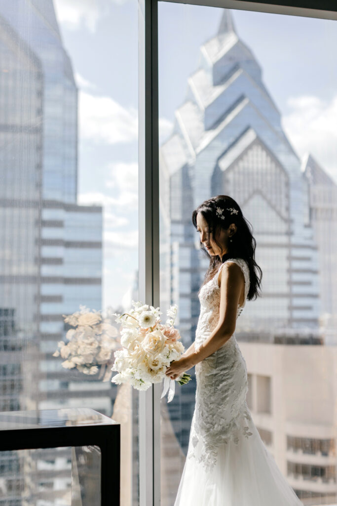 portrait of a bride with Philadelphia city skyline by Emily Wren Photography