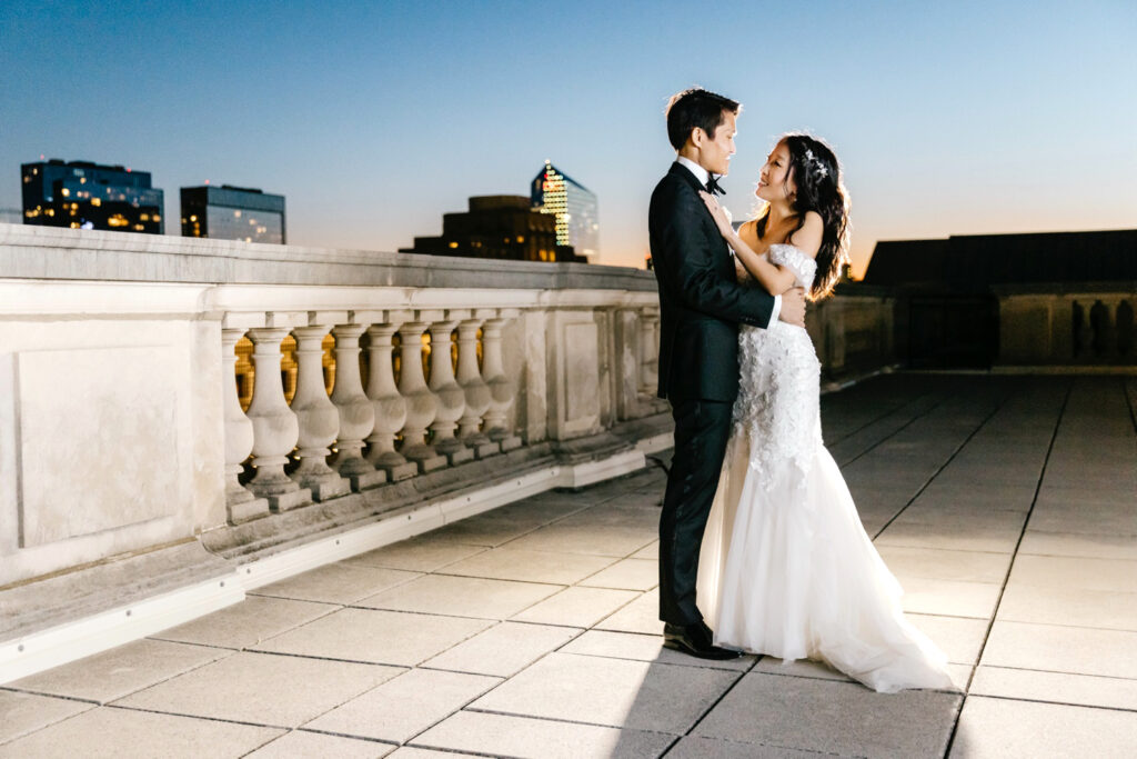 portrait of bride & groom on Free Library of Philadelphia rooftop during sunset by Emily Wren Photography