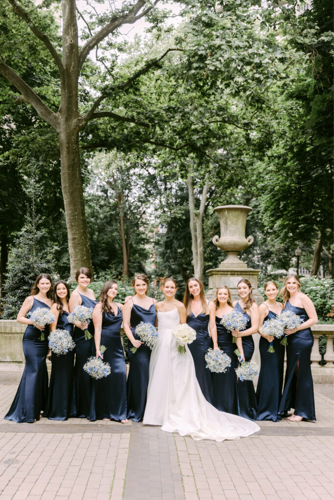 bride with bridesmaids dressed in navy blue bridesmaid dresses