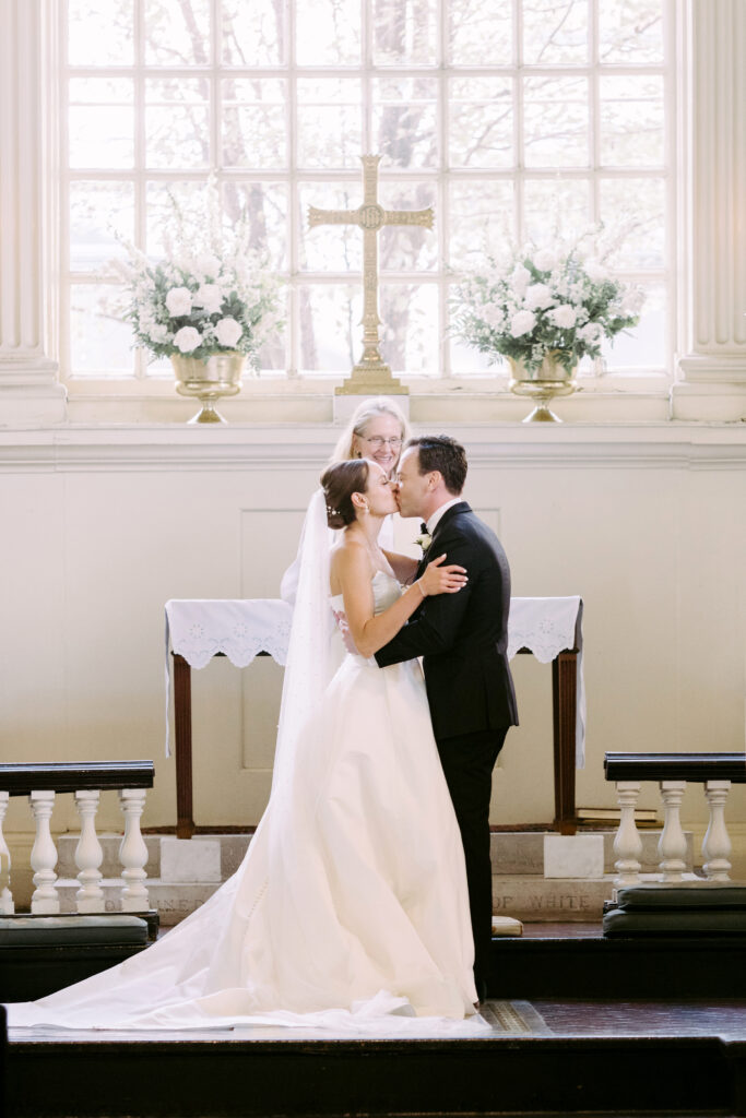 bride & grooms first kiss at church wedding ceremony in Philadelphia by Emily Wren Photography