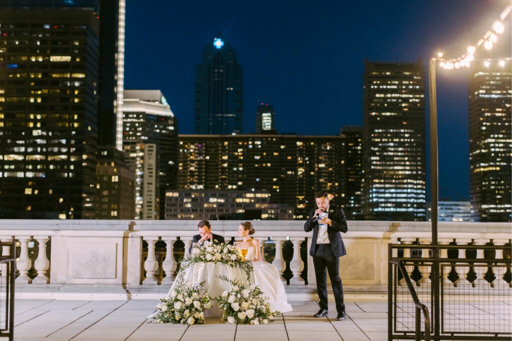 summer rooftop wedding reception at the Free Library of Philadelphia with Philadelphia cityscape in the beautiful night sky