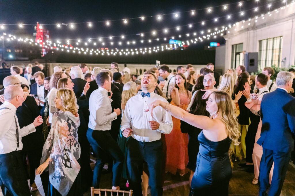 guests dancing during Philadelphia rooftop wedding reception by Emily Wren Photography