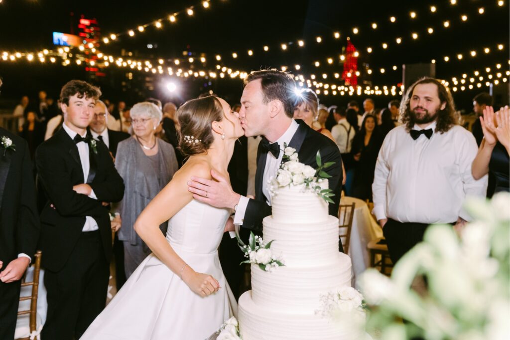 bride & groom cutting their wedding cake during summer Philadelphia wedding reception by Emily Wren Photography