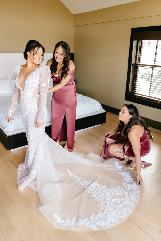 bride getting ready in her luxury Berta wedding gown by Emily Wren Photography