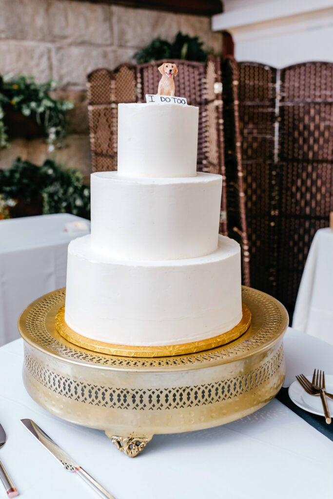 3 tier minimalist wedding cake with golden retriever cake topper