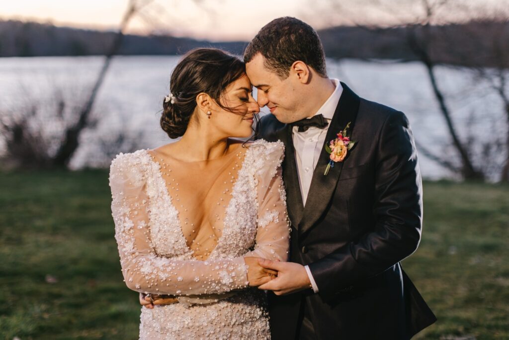 bride & groom wedding portrait during sunset by a lake by Emily Wren Photography