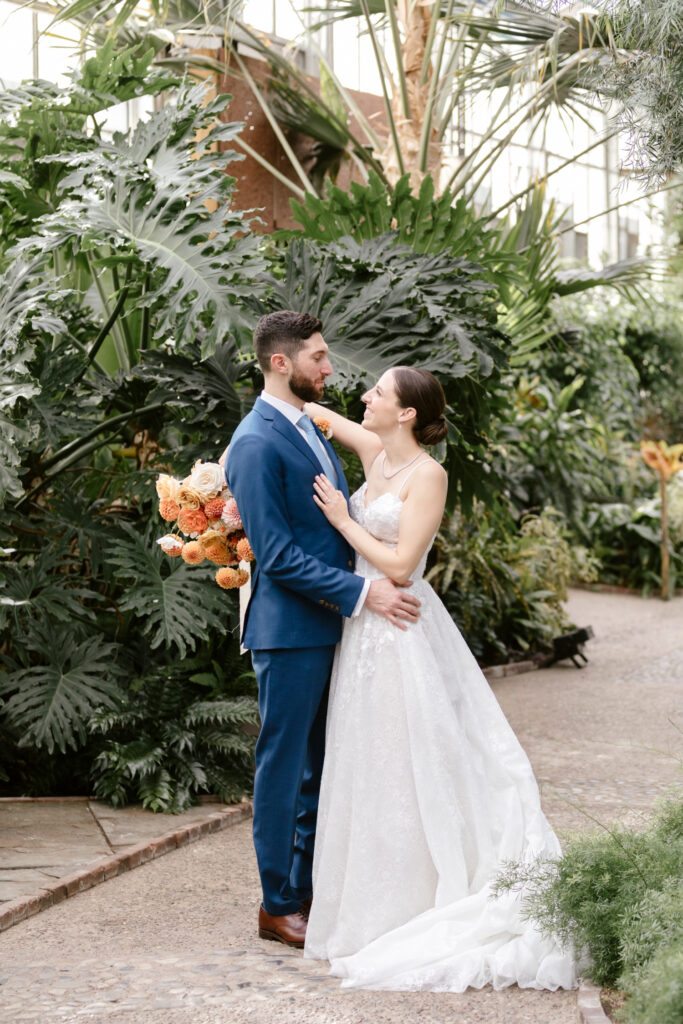 portrait of bride & groom surrounded by greenery at Fairmount Horticultural Center by Philadelphia wedding photographer Emily Wren Photography