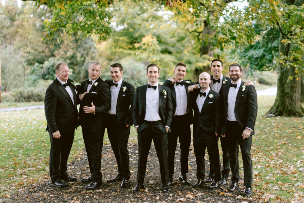 groom with groomsmen dressed by Suit Supply