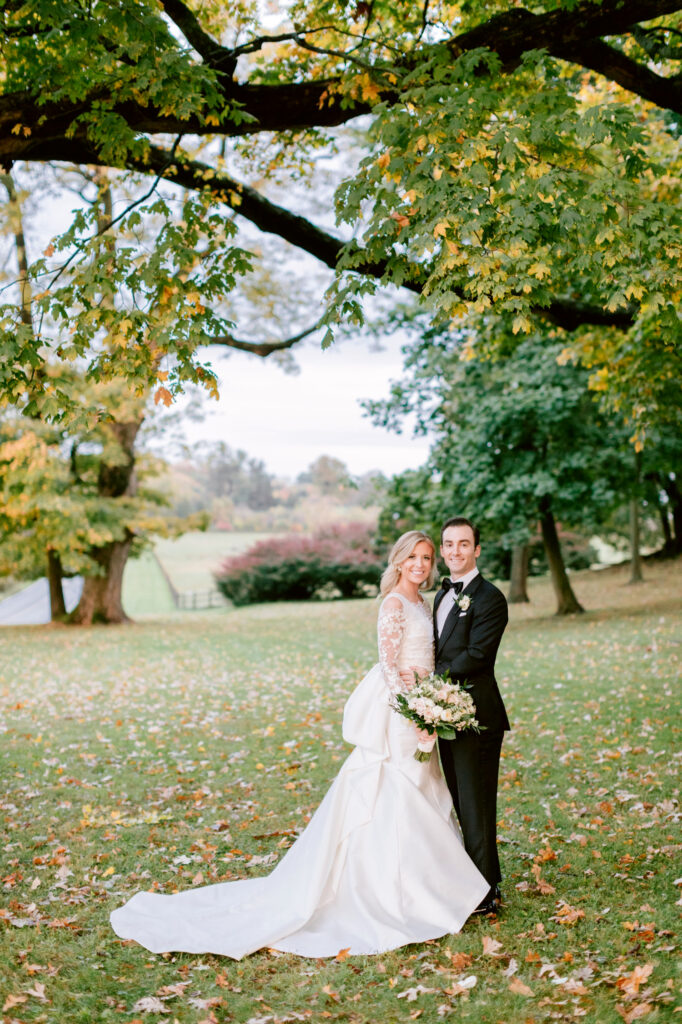 bride & groom during Fall wedding at Radnor Hunt by Emily Wren Photography