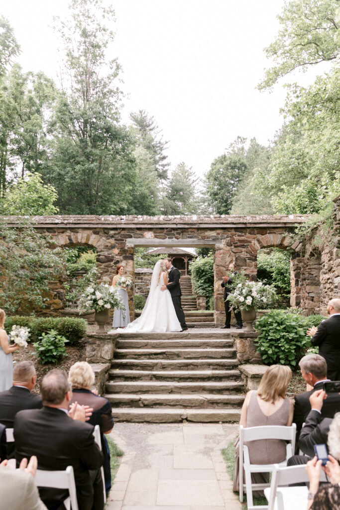 bride & grooms first kiss at outdoor wedding ceremony at Parque Ridley Creek by Emily Wren Photography