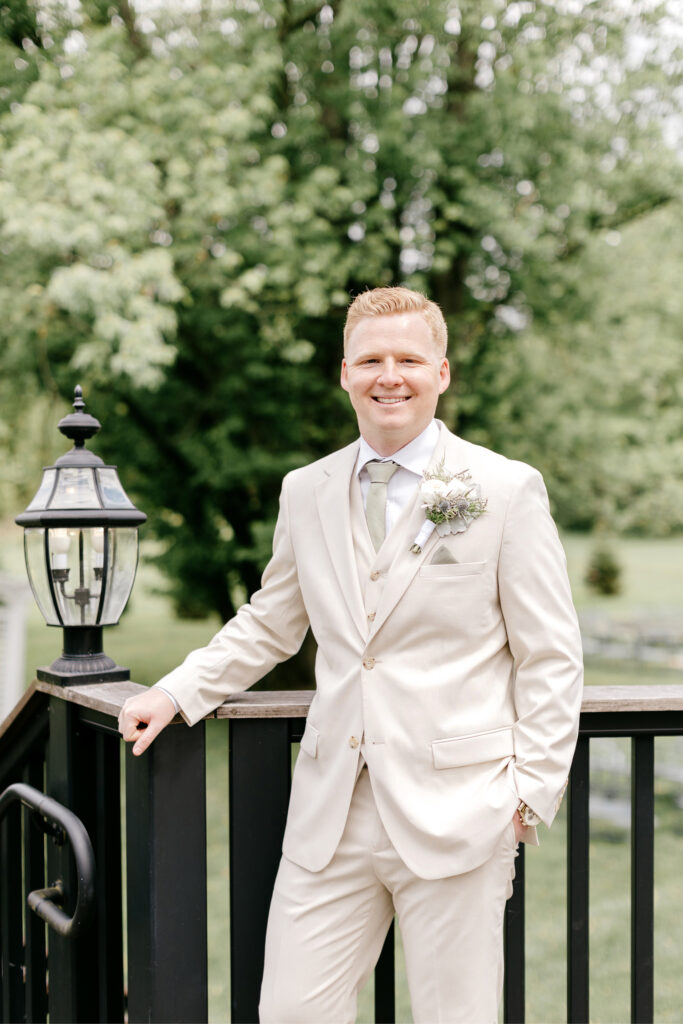 portrait of the groom before his summer wedding at the inn at barley sheaf