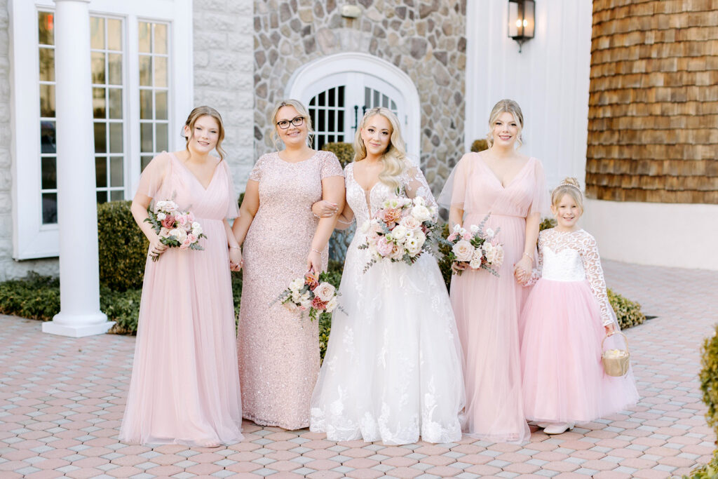 bride with her bridesmaids in pink bridesmaid dresses