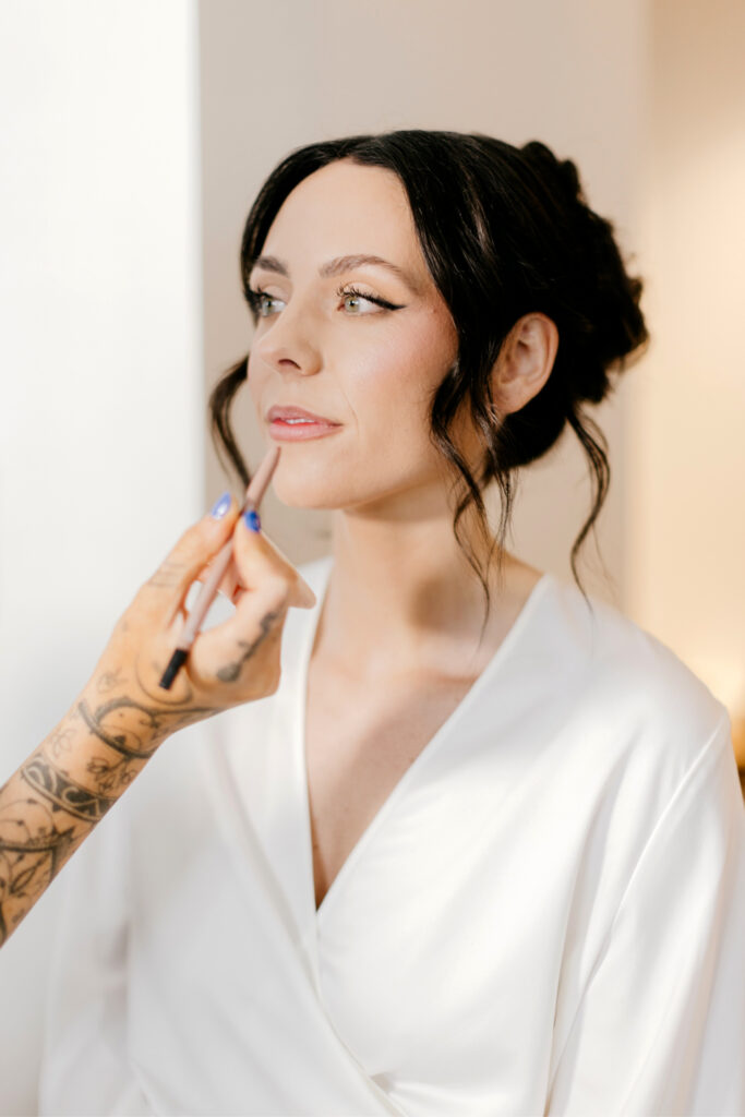 bride getting her bridal makeup done by Philadelphia wedding photographer Emily Wren Photography