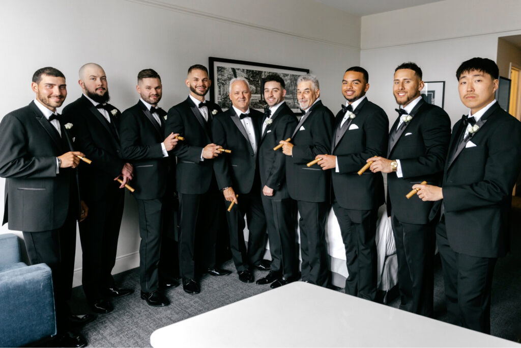 groom with groomsmen smoking cigars