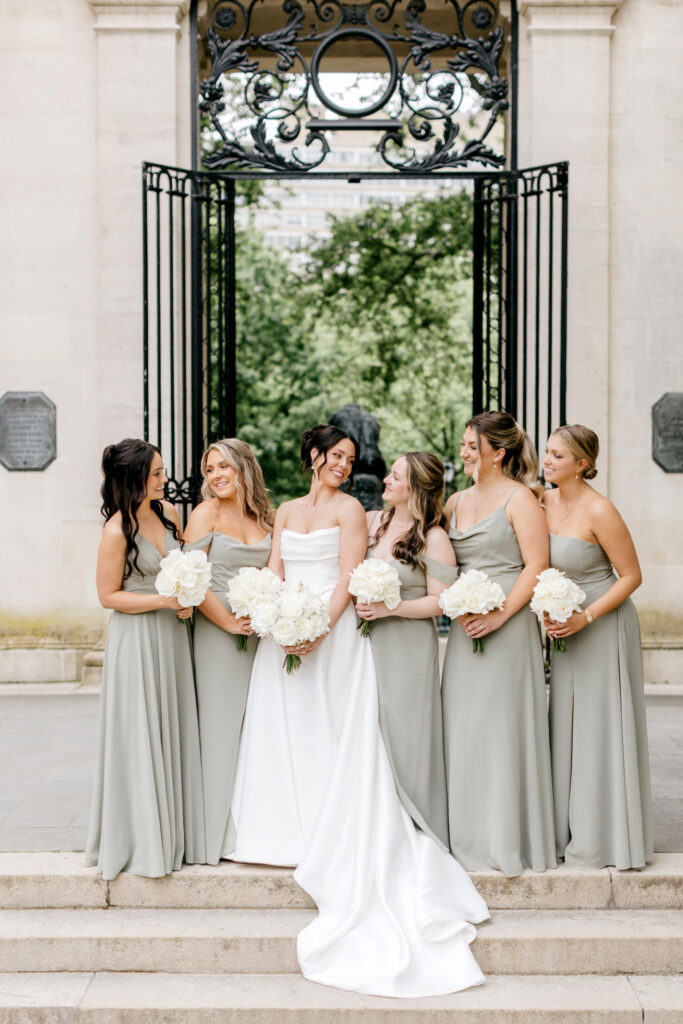 bride with bridesmaids in sage green bridesmaid dresses for summer wedding