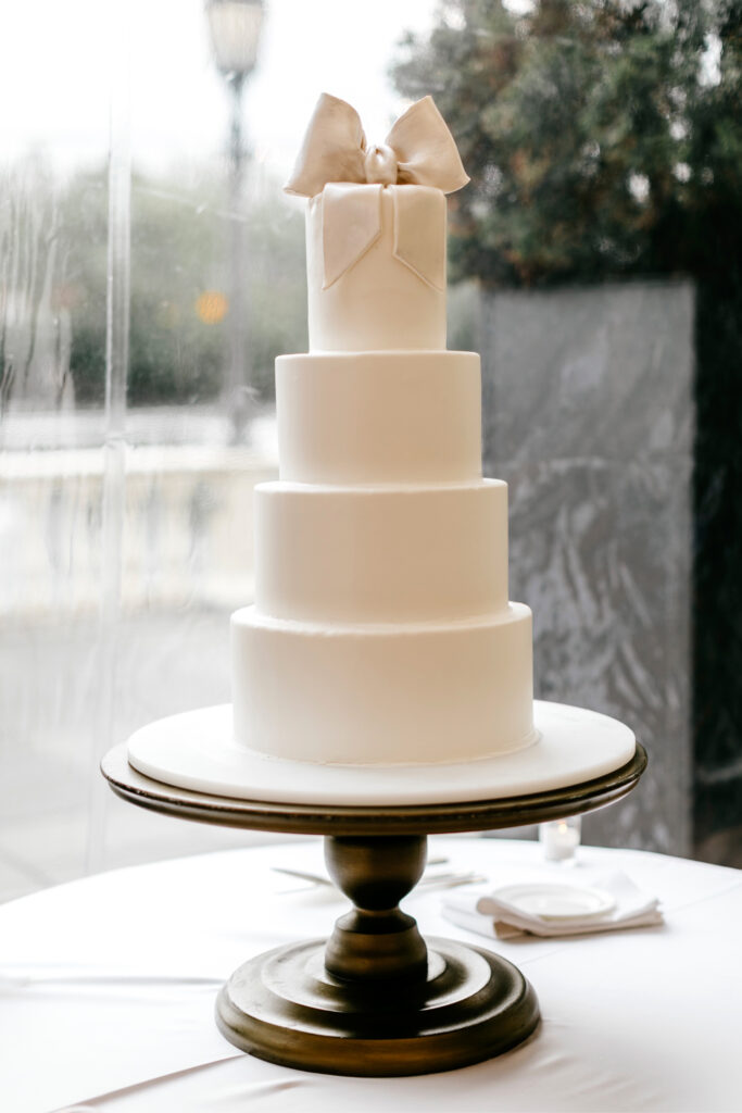 4 tier wedding cake with big white bow