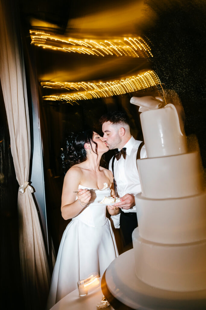 bride & groom cutting their 4 tier wedding cake at their Cescaphe Water Works Wedding by Emily Wren Photography