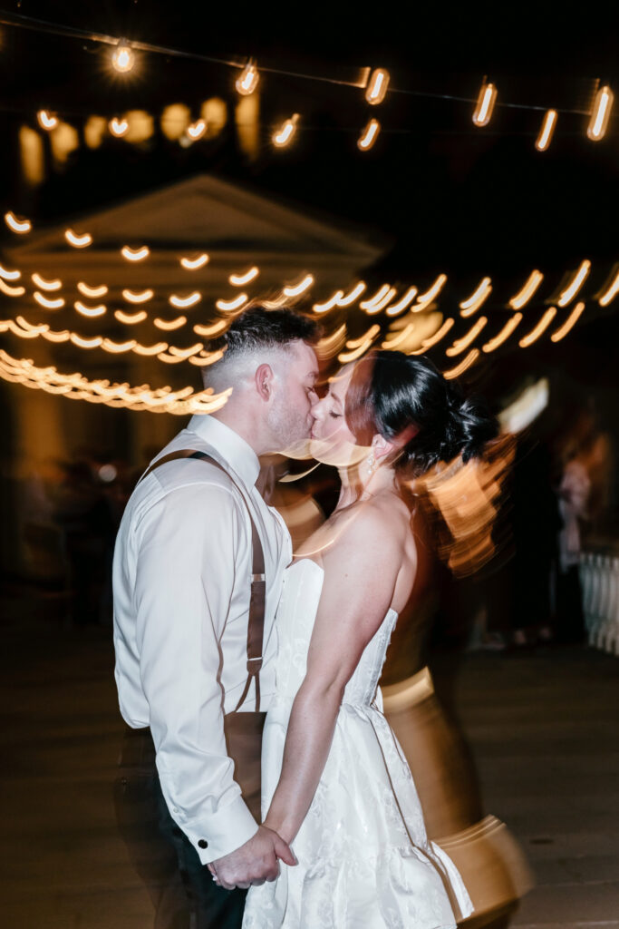 bride and groom kissing at their Cescaphe wedding reception by Emily Wren Photography