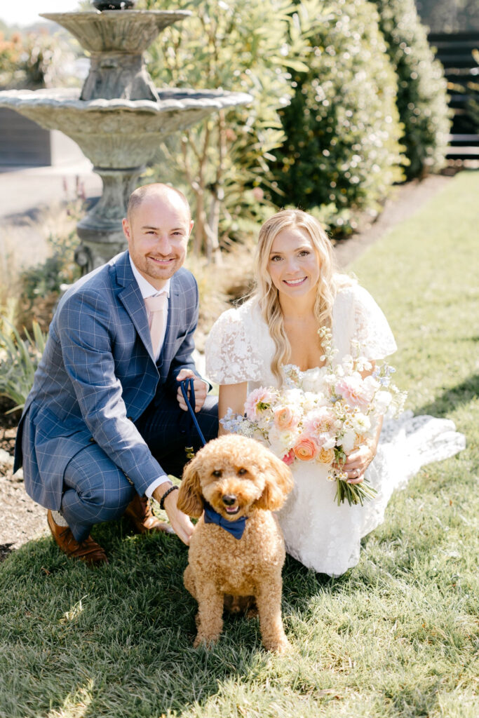 bride and groom with their pet dog on their wedding day