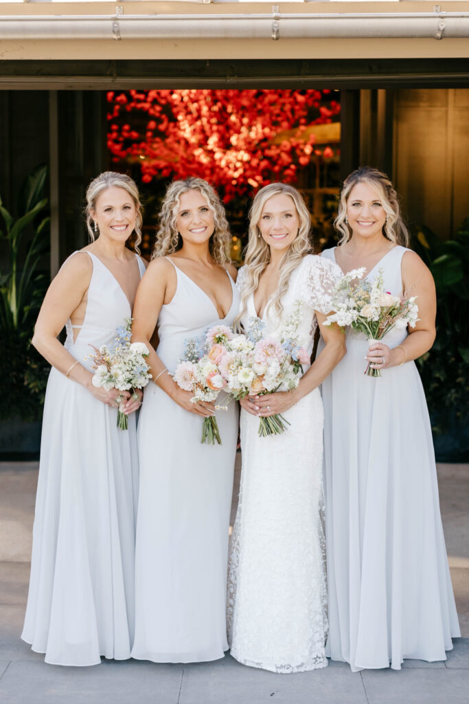 bride with bridesmaids in light blue bridesmaid dresses