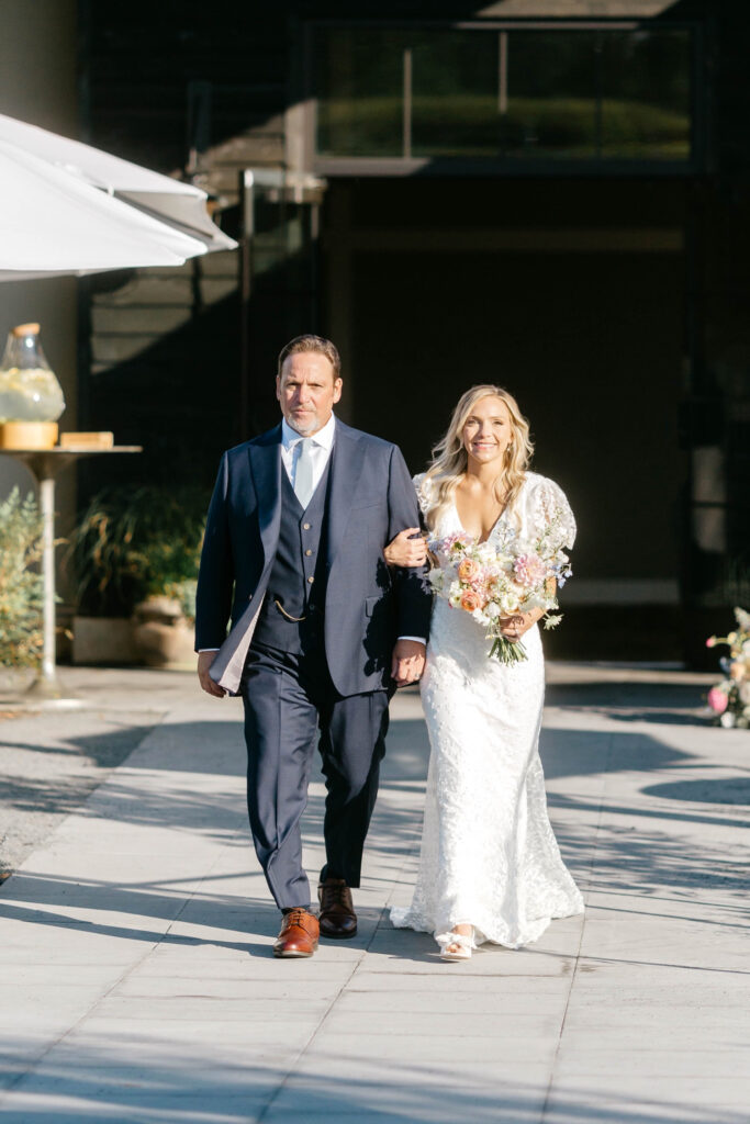 bride walking down the aisle at her outdoor wedding ceremony at Terrain at DelVal