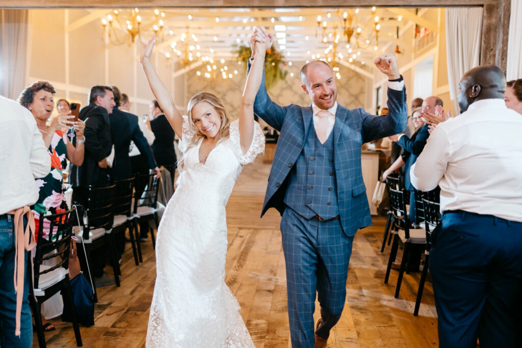 bride & groom entering Terrain Gardens wedding reception by Emily Wren Photography