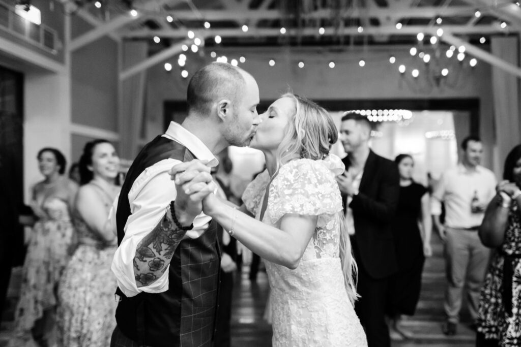 bride & groom kissing at their Terrain wedding reception by Emily Wren Photography