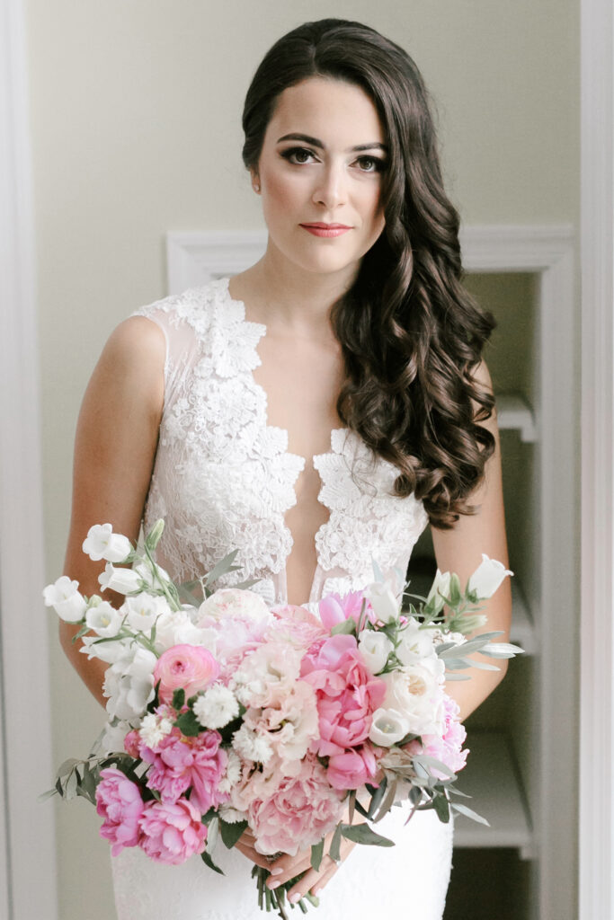 Summer bride with her pink floral wedding day bridal bouquet