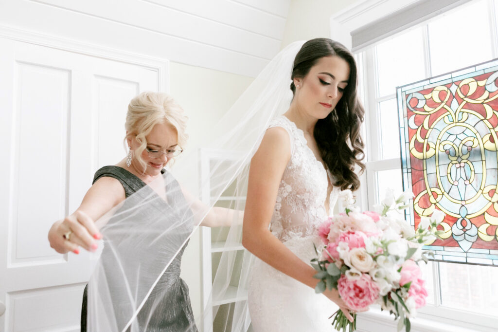 New Jersey bride putting her sheer veil on by Emily Wren Photography