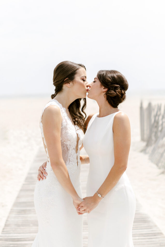 LGBTQ brides kissing on New Jersey beach by Emily Wren Photography