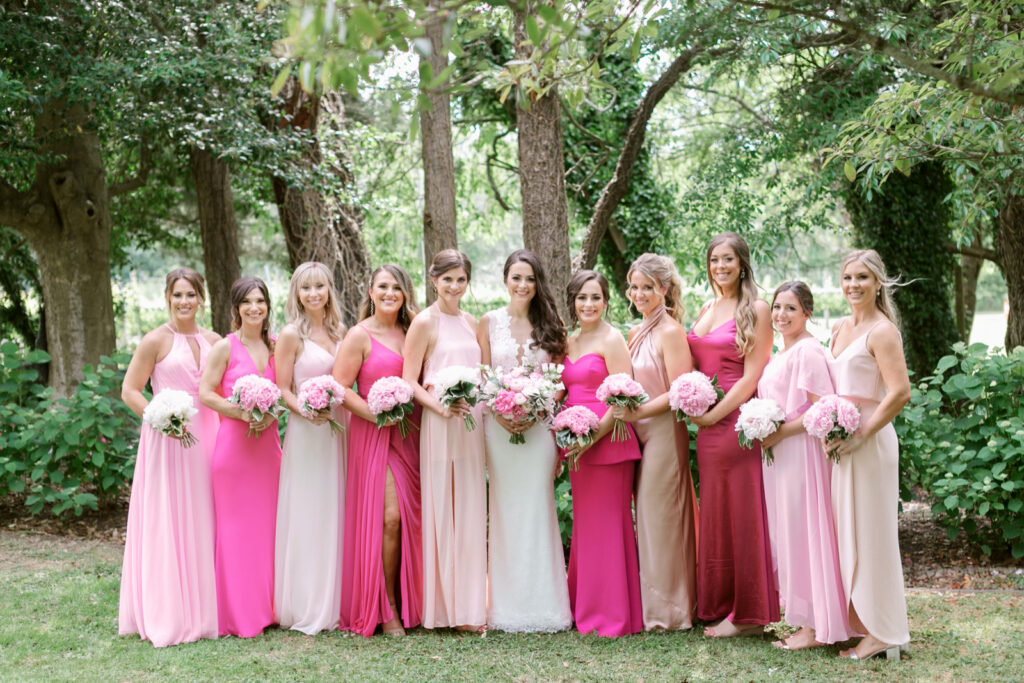 bride with bridesmaids in hot pink and blush pink bridesmaid dresses for summer wedding day