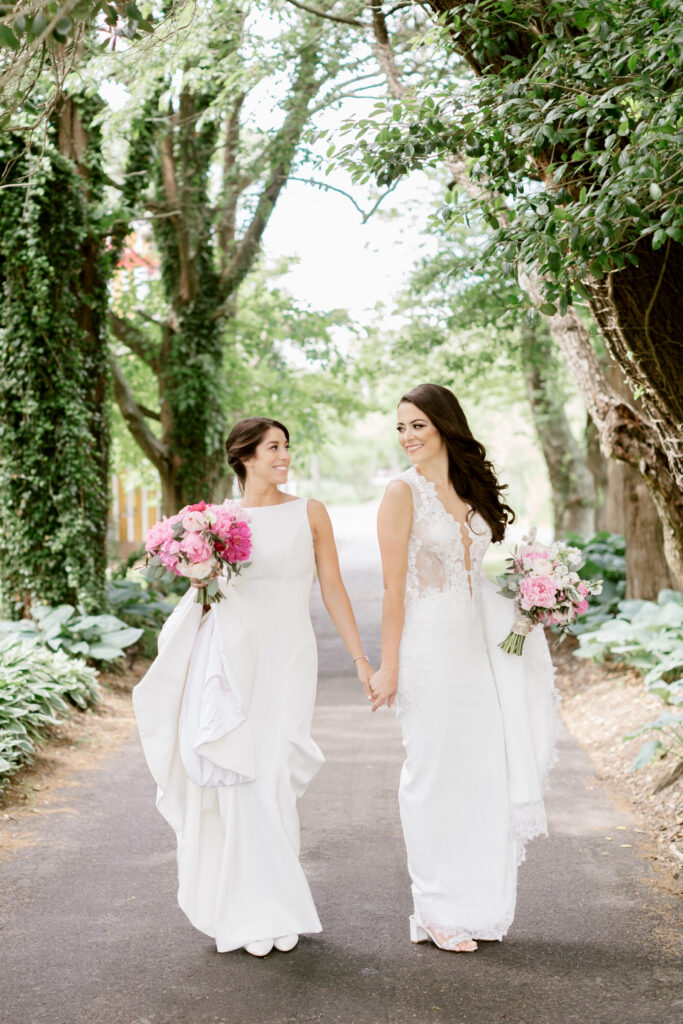 gay brides walking in a New Jersey garden in Cape May by Emily Wren Photography