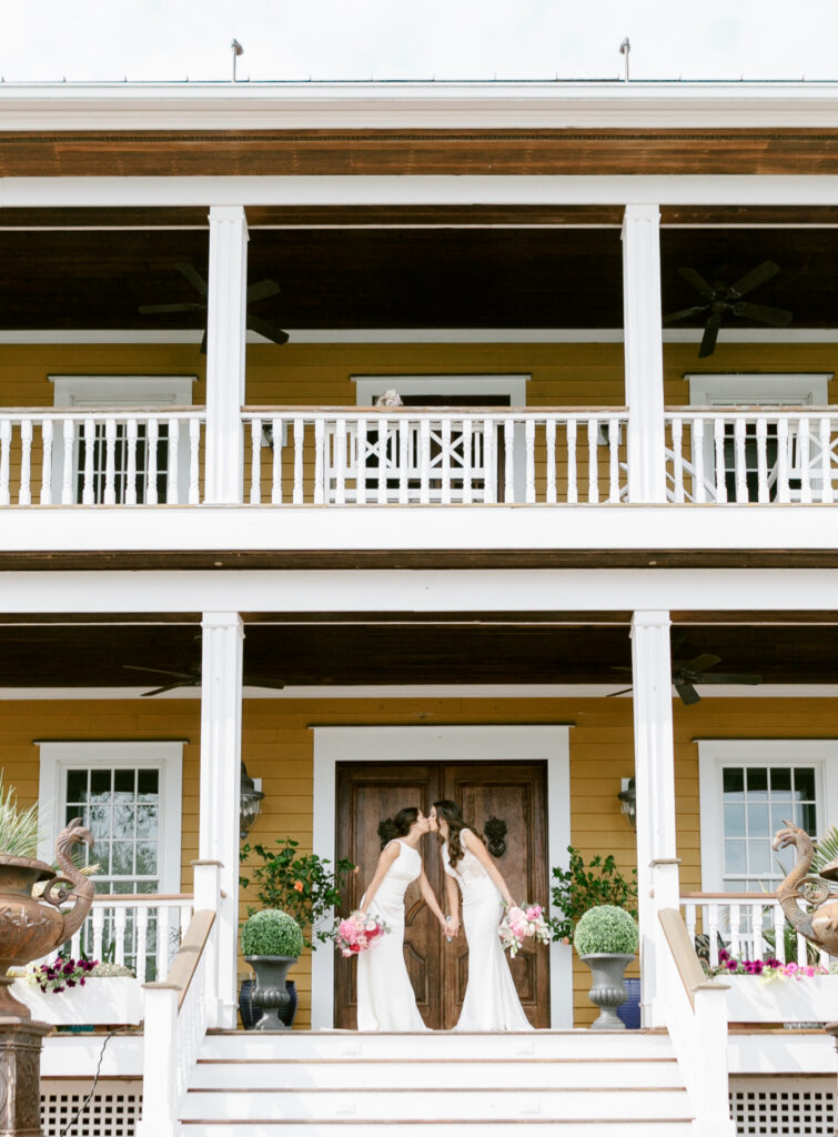 Same sex brides kissing at Willow Creek Winery in Cape May New Jersey