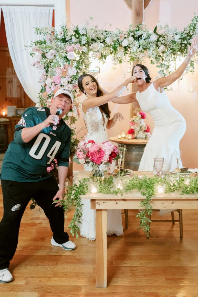 brides dancing and singing during Willow Creek Winery wedding reception by Emily Wren Photography