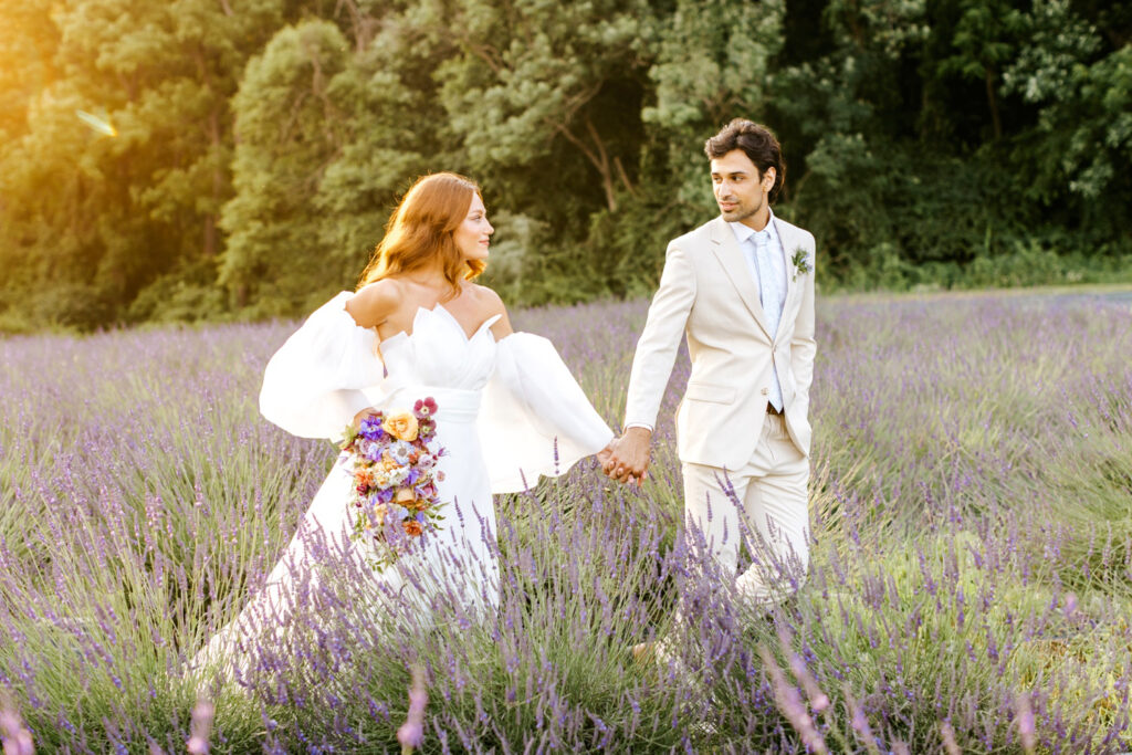 bride & groom walking through Lavender Fields in Pennsylvania during sunset by Emily Wren Photography