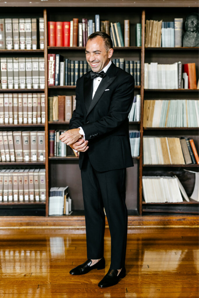 Philadelphia groom getting ready in a library