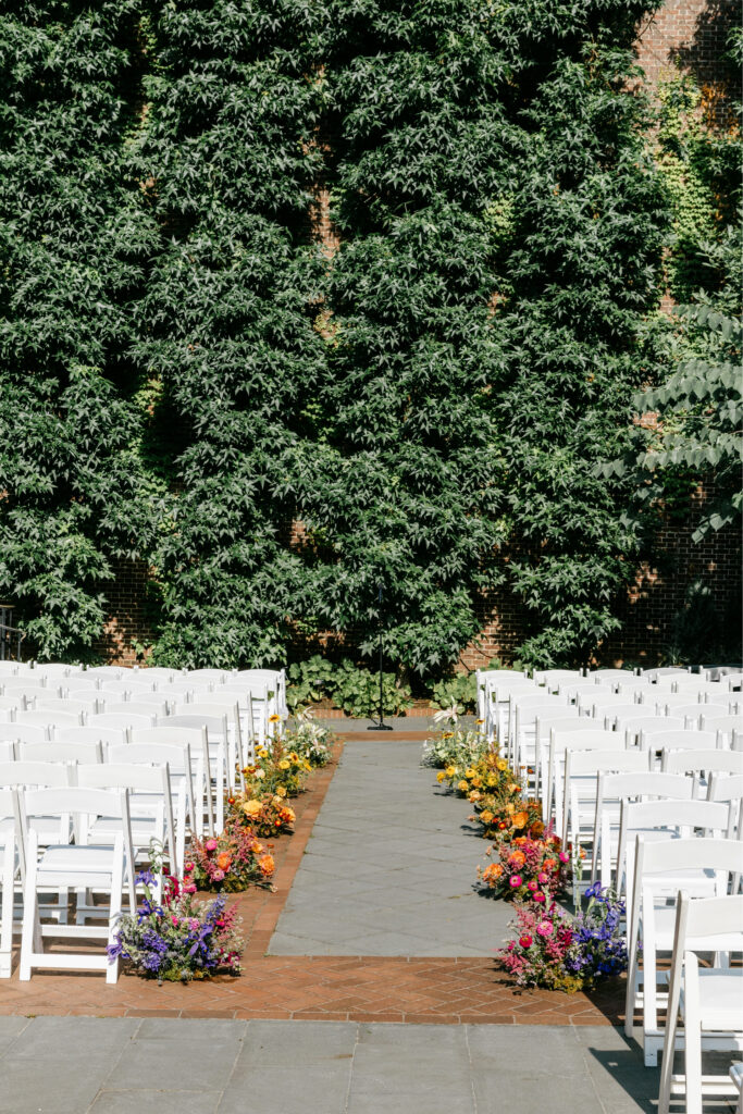 College of Physicians wedding ceremony with LGBTQ flowers aligning the aisle