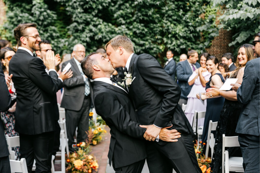 grooms exiting their same sex wedding ceremony by Emily Wren Photography