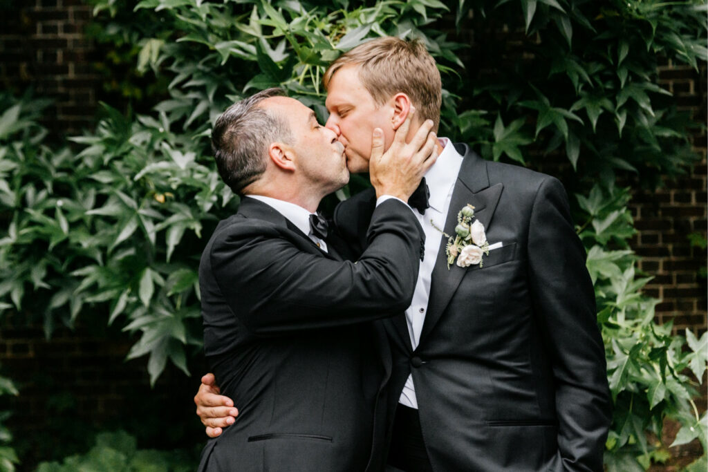 LGBTQ grooms kissing in Mutter Museum garden by Philadelphia wedding photographer Emily Wren Photography