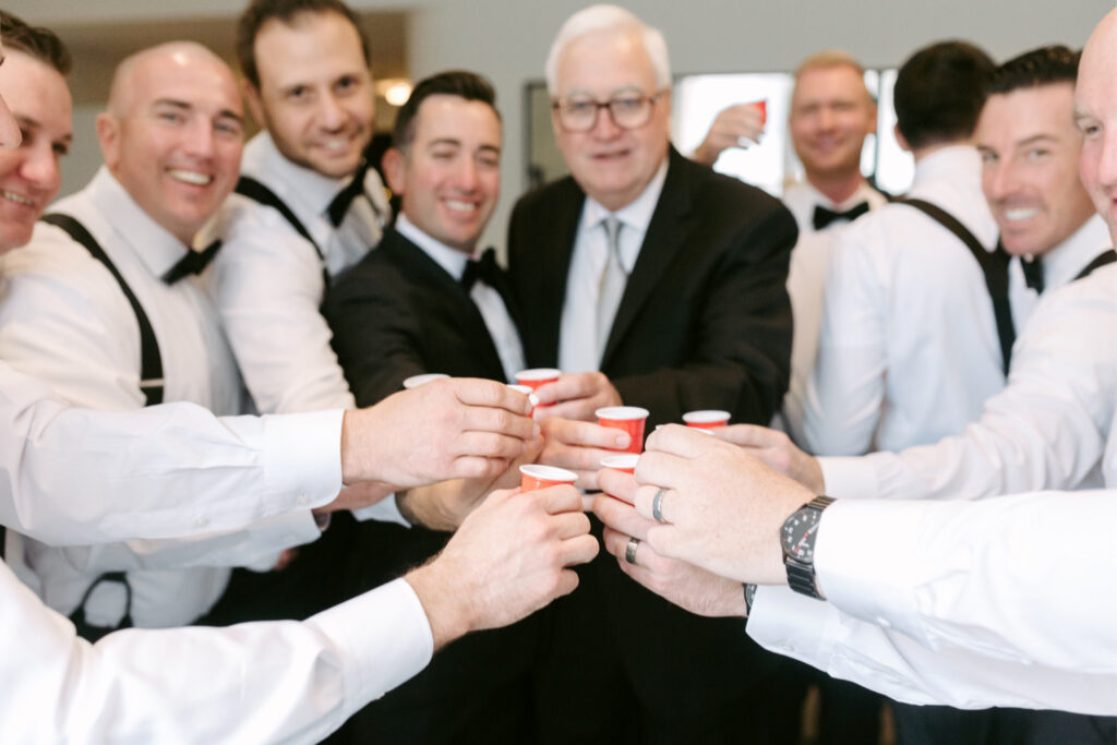 groom taking shots with his groomsmen before his Philadelphia wedding day