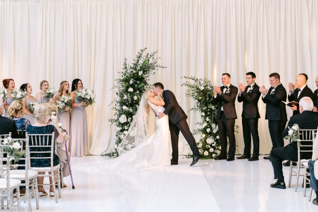 bride and groom's first kiss at Cescaphe wedding ceremony by Emily Wren Photography